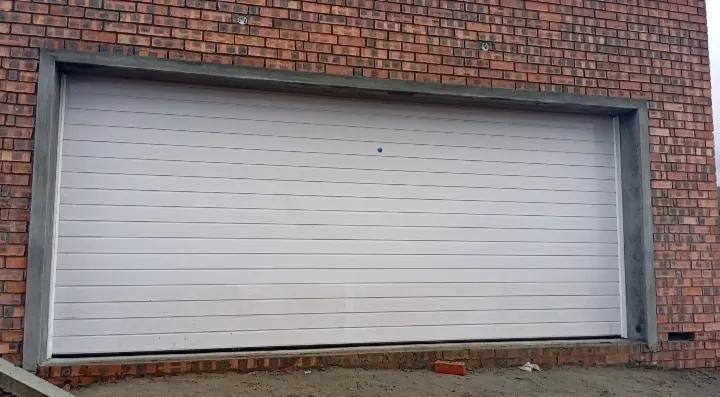 White double sectional garage door in a face-brick wall